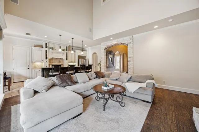 a large kitchen with granite countertop lots of counter space and wooden floor