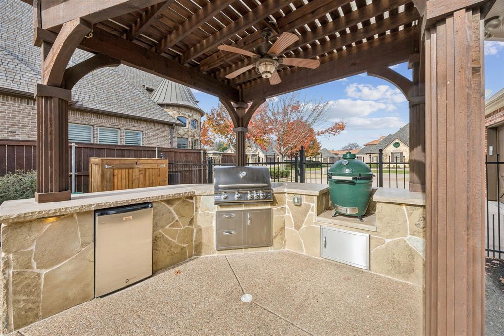 1411 Long And Winding Road Mansfield, TX 76063 - Photo 35 of 37 outdoor kitchen, with out door grill, fridge and storage