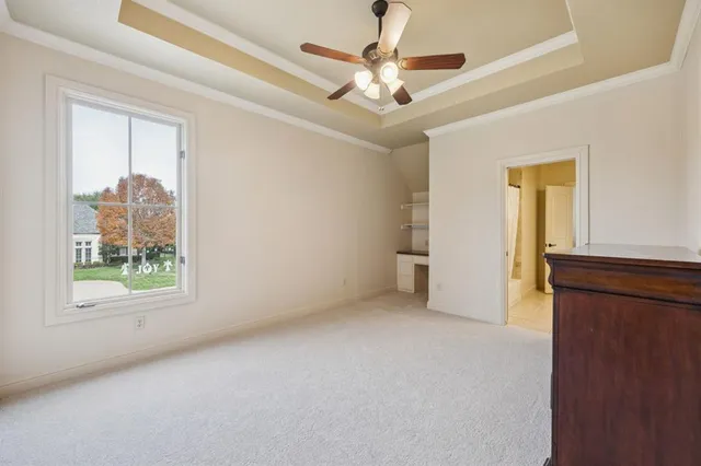 en empty room with windows and ceiling fan