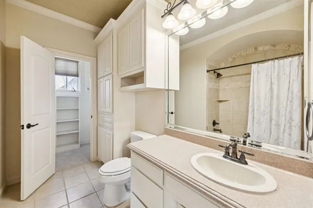 a bathroom with a sink a toilet and shower a mirror