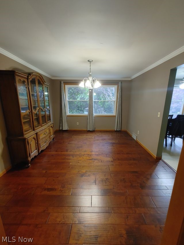 2211 Devonshire Road Northwest Canton, OH 44708 - Photo 4 of 36 Unfurnished dining area featuring a chandelier, ornamental molding, and dark hardwood / wood-style floors
