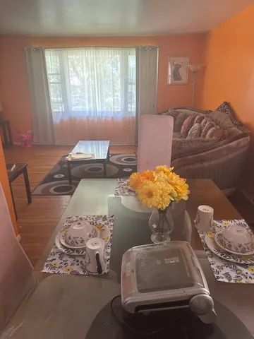 a living room with furniture and flowers