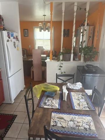 a kitchen with a stove a refrigerator and a stove top oven