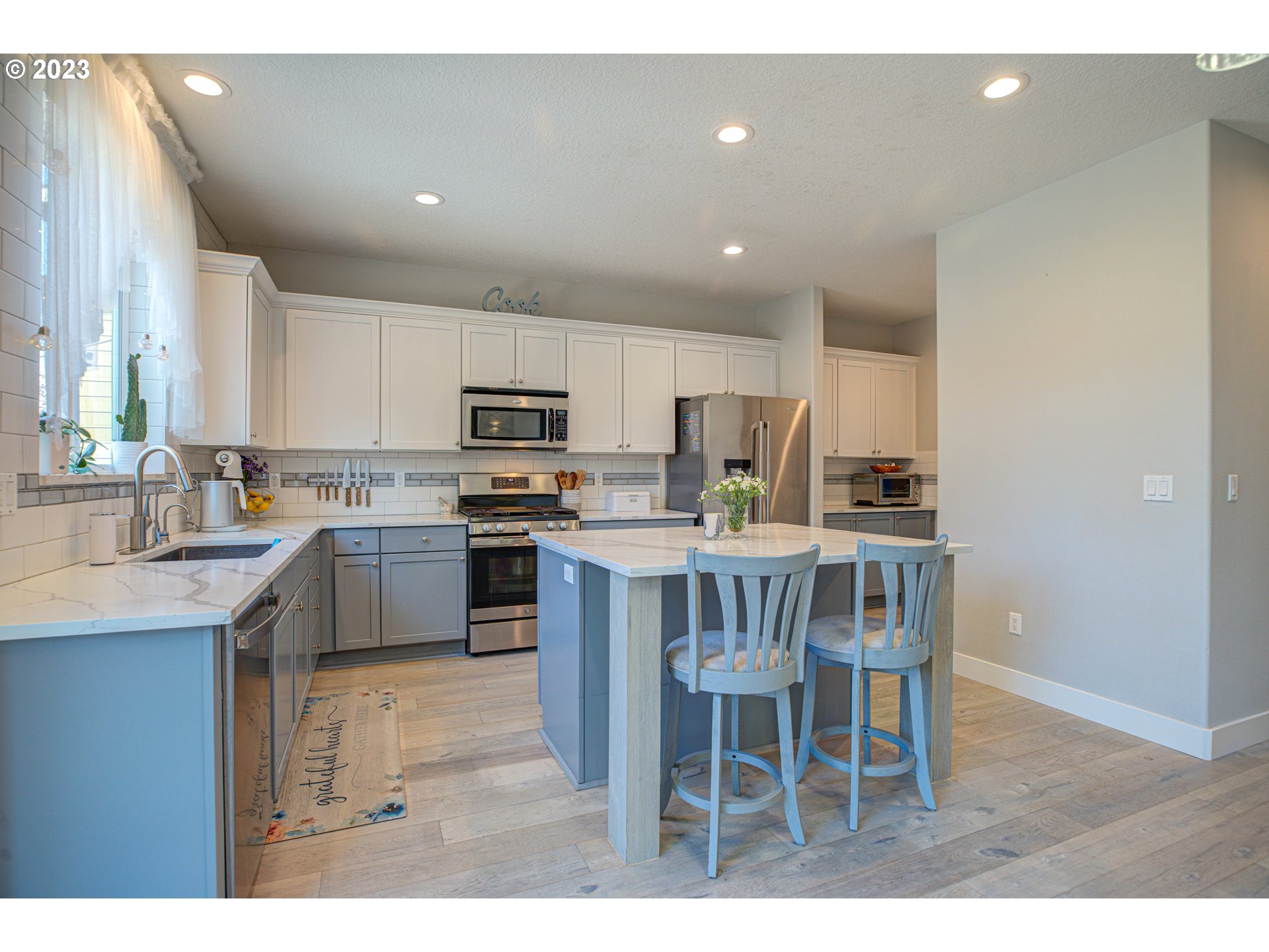 6055 Southeast 28th Street Gresham, OR 97080 - Photo 23 of 48 a kitchen with kitchen island granite countertop a sink and counter space