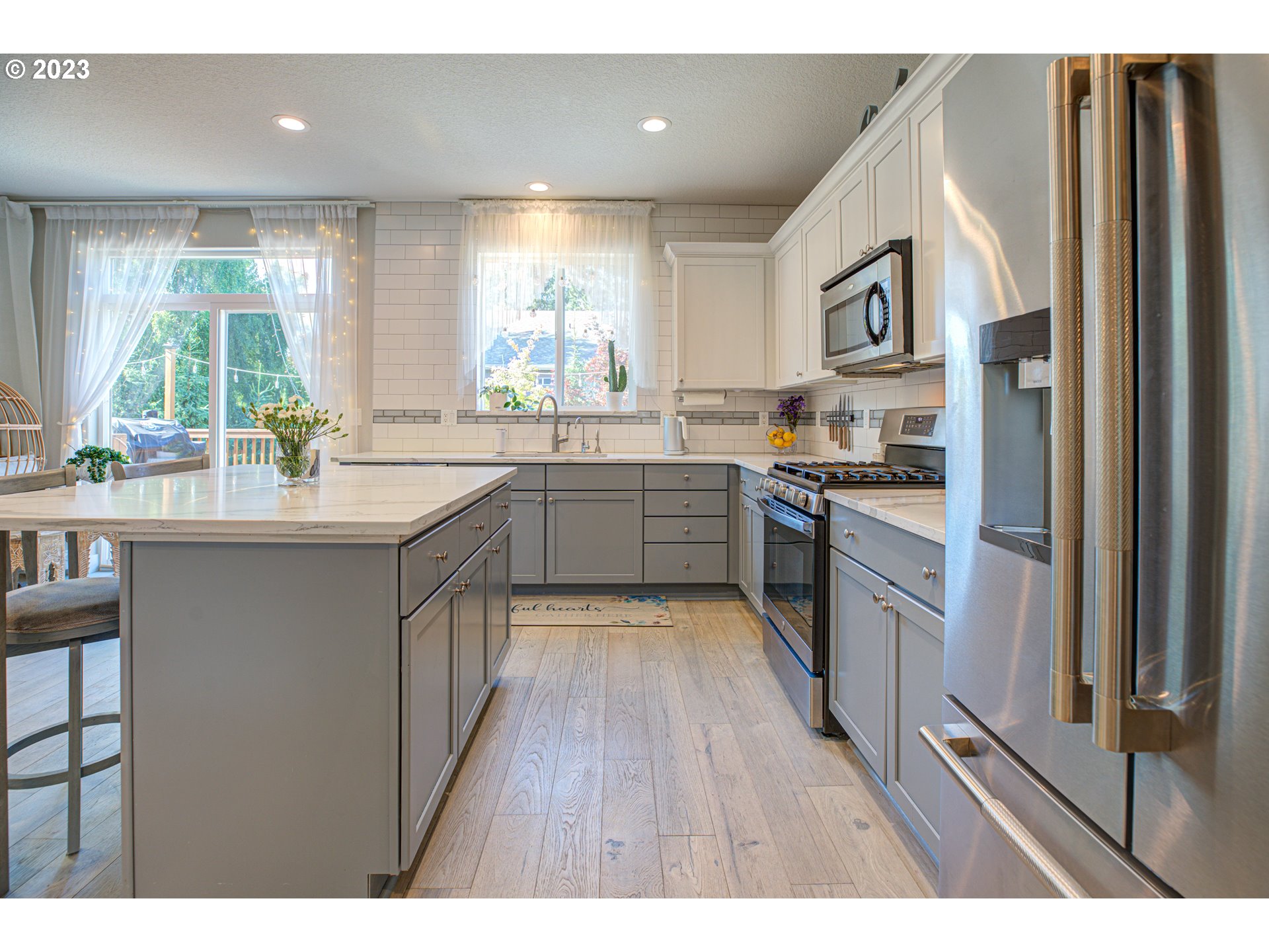 6055 Southeast 28th Street Gresham, OR 97080 - Photo 26 of 48 a kitchen with stainless steel appliances granite countertop a stove a sink dishwasher and a refrigerator with wooden floor