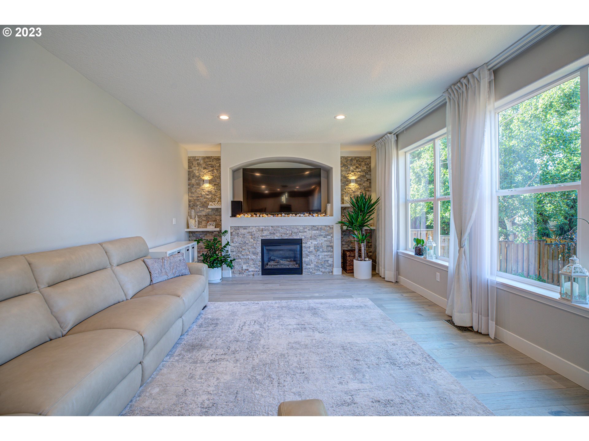 6055 Southeast 28th Street Gresham, OR 97080 - Photo 28 of 48 a living room with furniture a fireplace and a flat tv screen