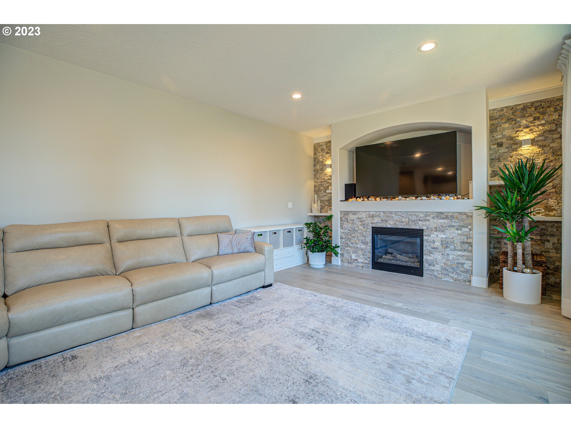 6055 Southeast 28th Street Gresham, OR 97080 - Photo 29 of 48 a living room with furniture a fireplace and a flat screen tv