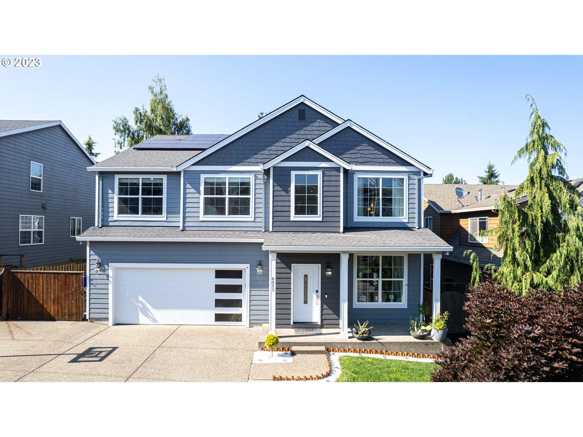 6055 Southeast 28th Street Gresham, OR 97080 - Photo 3 of 48 a front view of a house with a yard