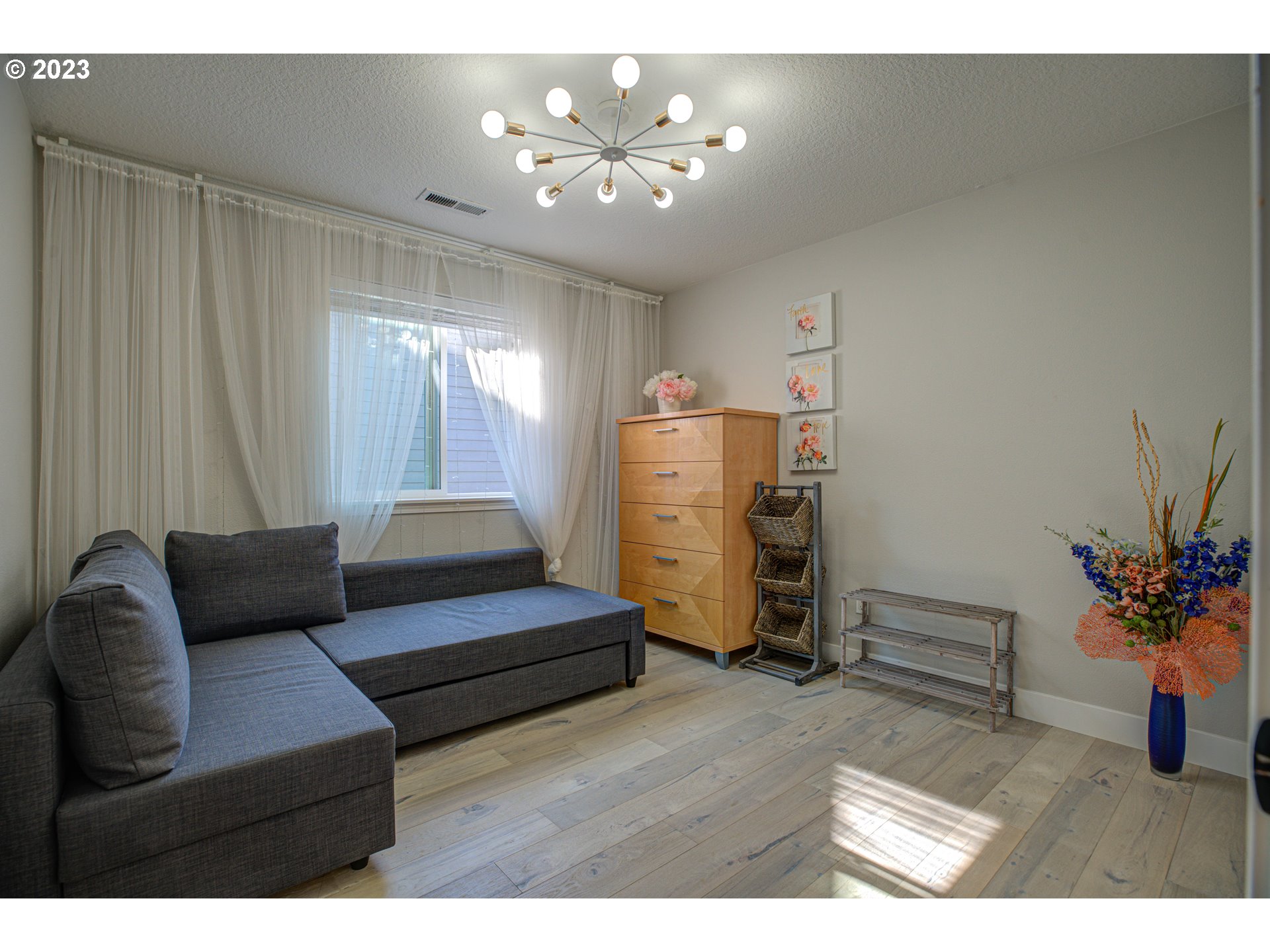 6055 Southeast 28th Street Gresham, OR 97080 - Photo 42 of 48 a living room with furniture and a chandelier