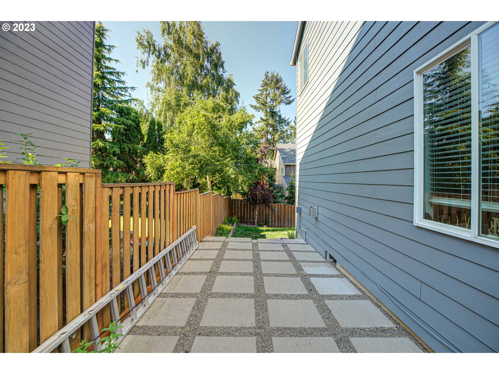 6055 Southeast 28th Street Gresham, OR 97080 - Photo 10 of 48 a view of backyard with wooden fence and large trees