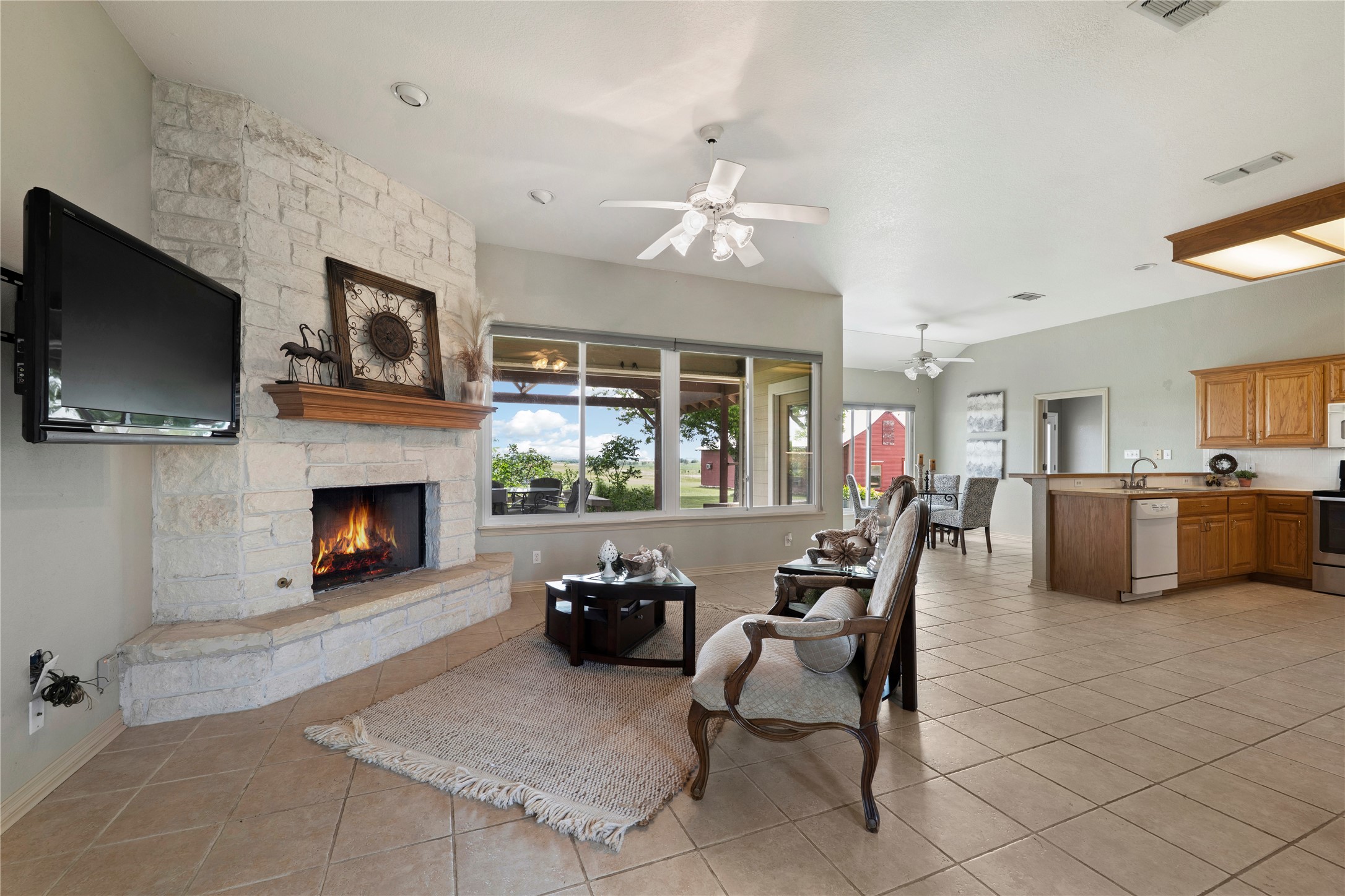 1005 East Buttercup Road Taylor, TX 76574 - Photo 21 of 38 a living room with furniture a flat screen tv and a fireplace