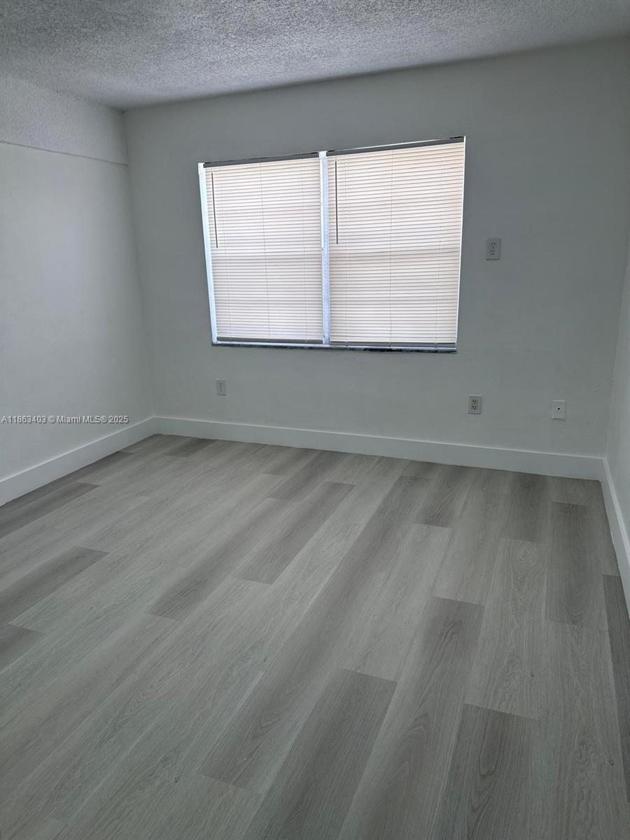 1000 West 28th Street, Unit 16 Hialeah, FL 33010 - Photo 12 of 13 an empty room with a window