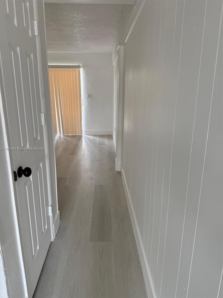 1000 West 28th Street, Unit 16 Hialeah, FL 33010 - Photo 4 of 13 a view of a hallway with wooden floor and staircase