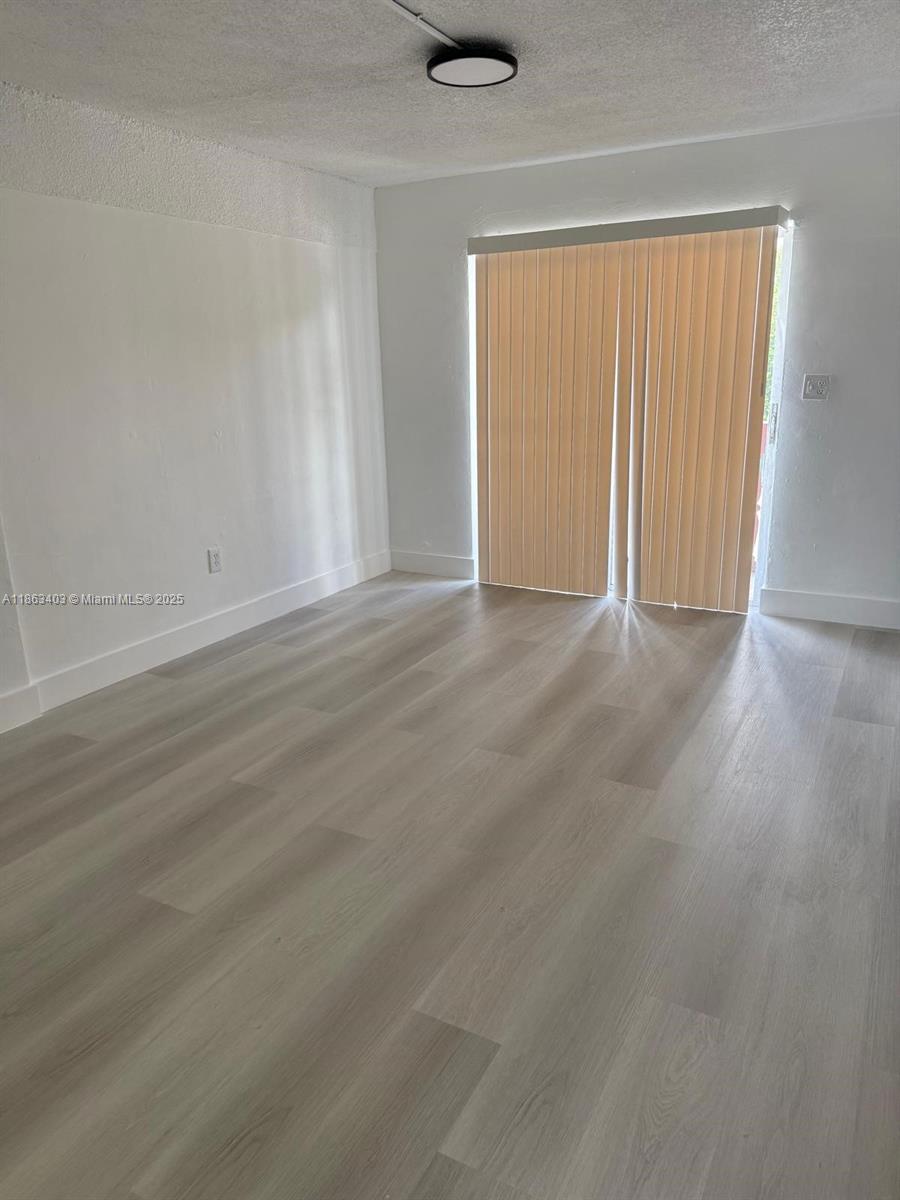1000 West 28th Street, Unit 16 Hialeah, FL 33010 - Photo 7 of 13 an empty room with a natural light