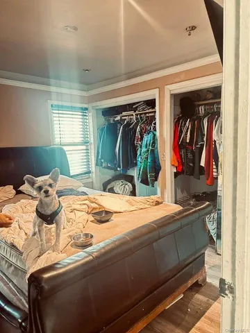 a bedroom with a bed and walk in closet