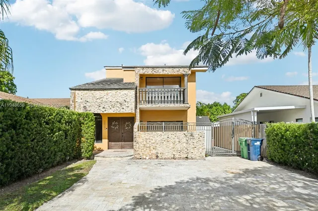a front view of a house with a garden