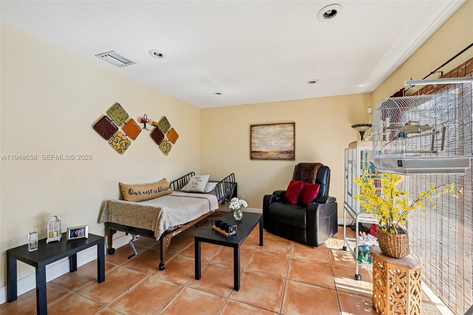 10365 Southwest 11th Terrace, Unit 49B Miami, FL 33174 - Photo 15 of 36 a living room with furniture and a flat screen tv