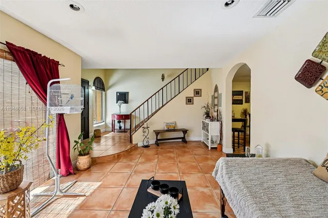 a view of a bedroom with wooden floor and stairs
