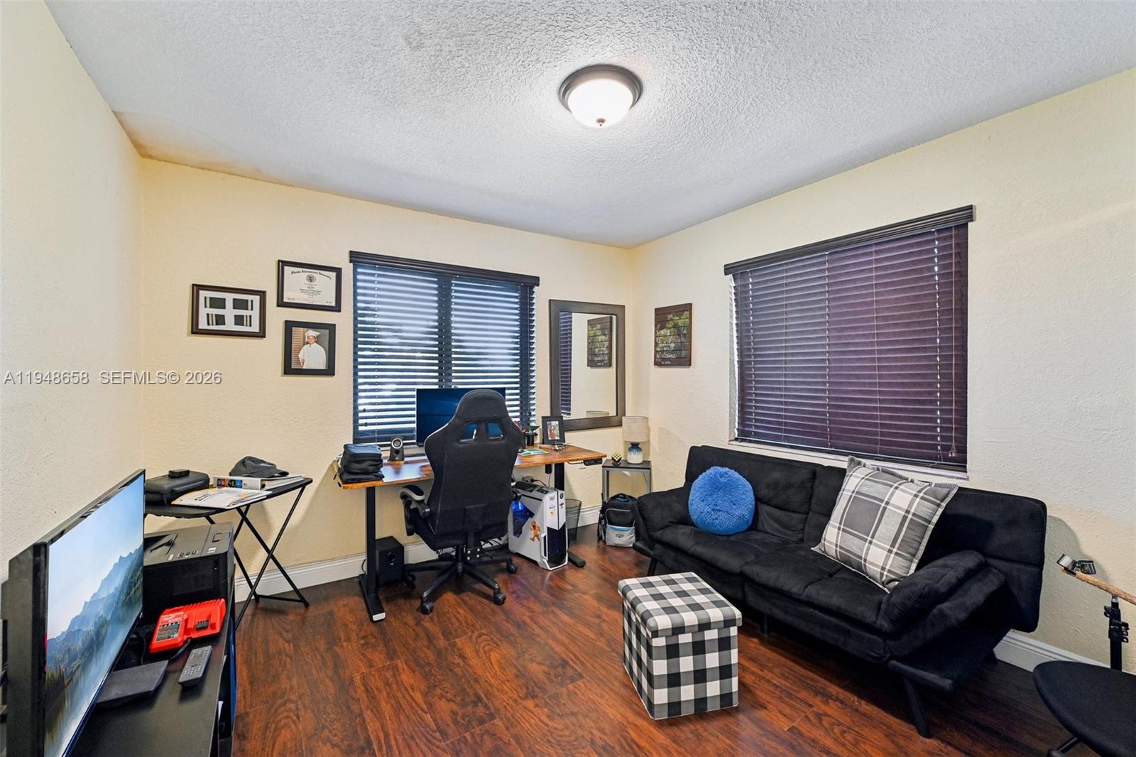 10365 Southwest 11th Terrace, Unit 49B Miami, FL 33174 - Photo 17 of 36 a living room with furniture and a wooden floor