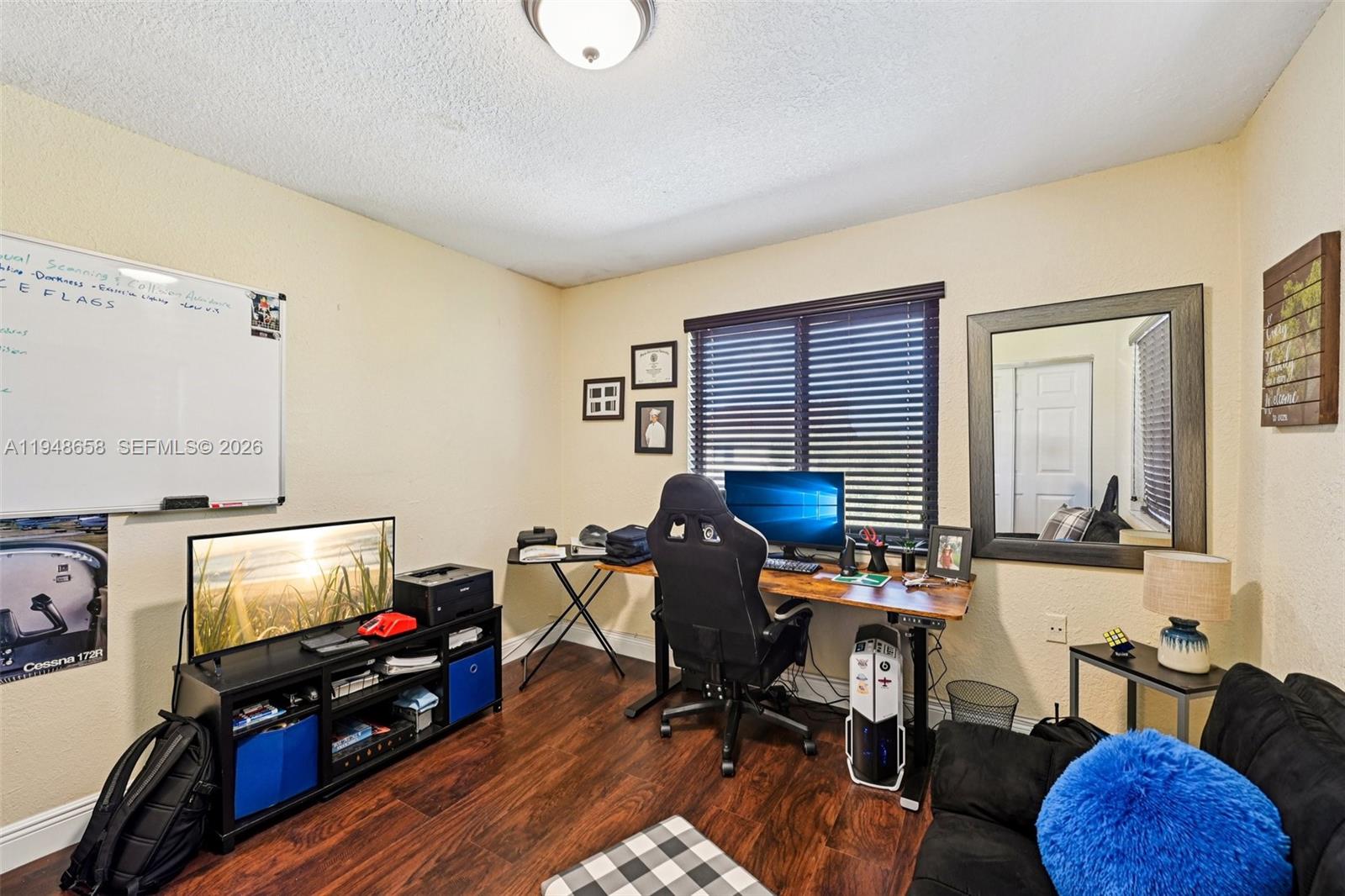 10365 Southwest 11th Terrace, Unit 49B Miami, FL 33174 - Photo 18 of 36 a room with furniture and a flat screen tv