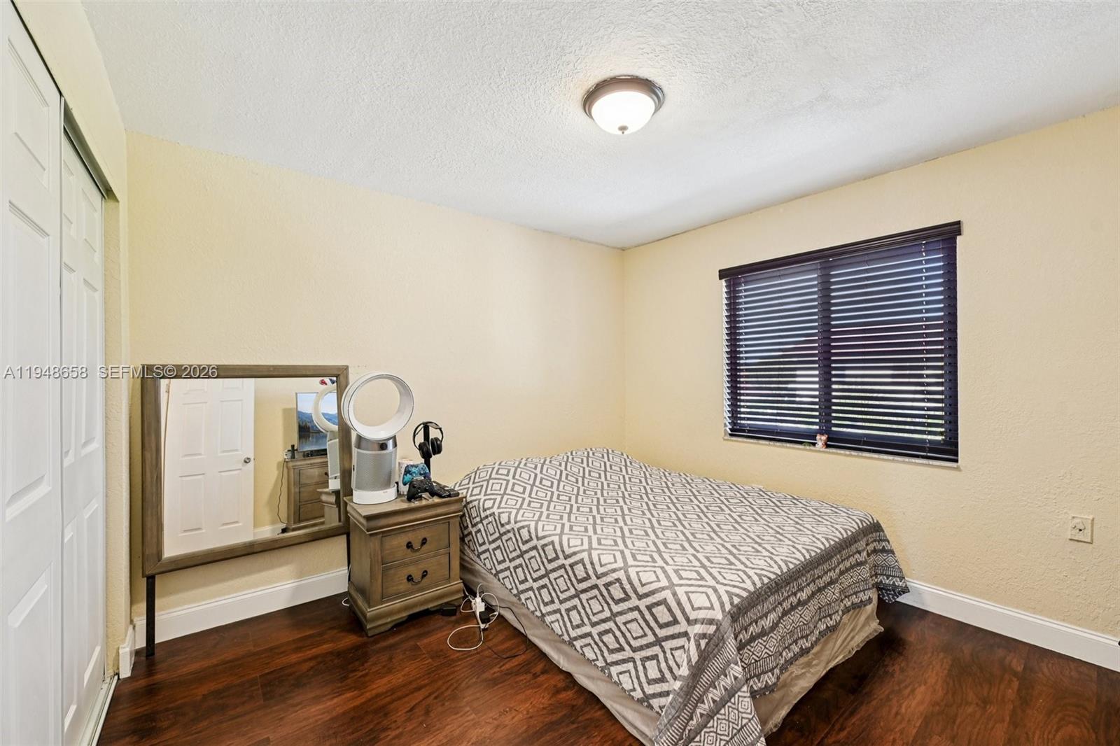 10365 Southwest 11th Terrace, Unit 49B Miami, FL 33174 - Photo 19 of 36 a room with a bed and wooden floor