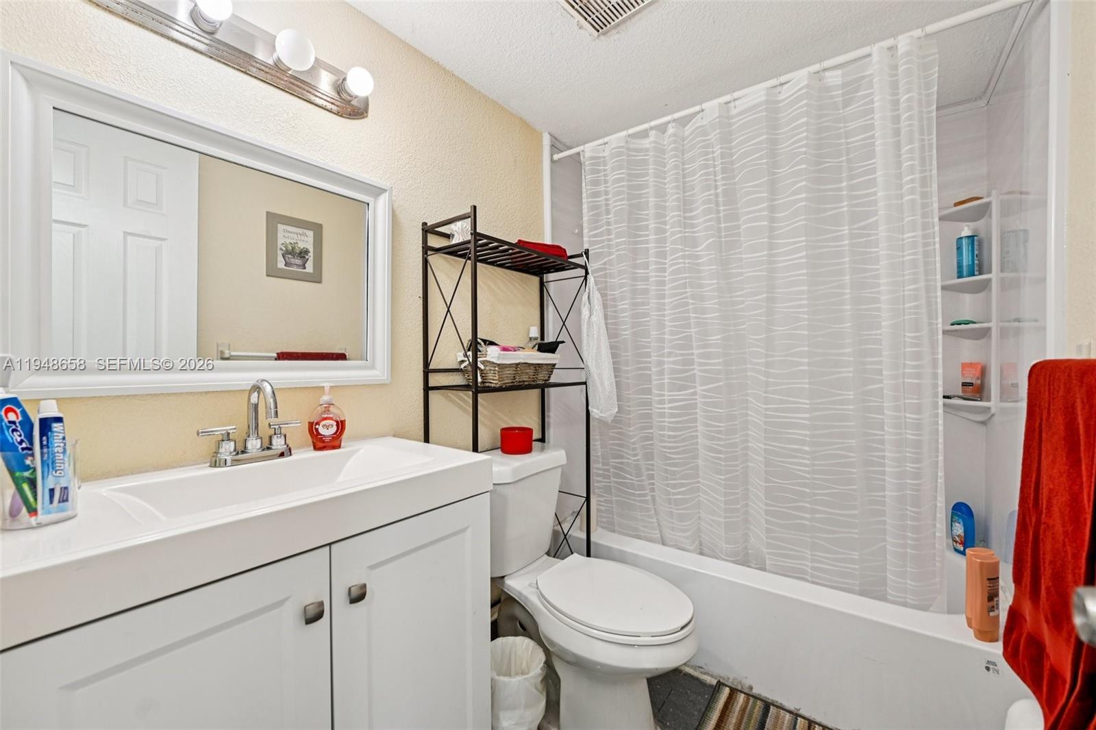 10365 Southwest 11th Terrace, Unit 49B Miami, FL 33174 - Photo 21 of 36 a bathroom with a sink toilet and shower