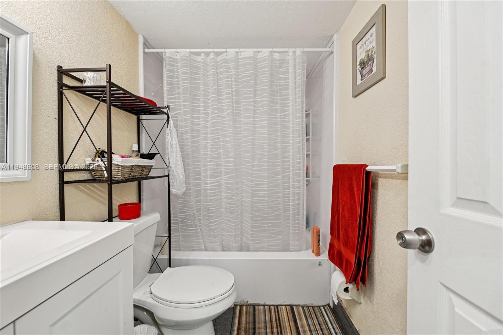 10365 Southwest 11th Terrace, Unit 49B Miami, FL 33174 - Photo 22 of 36 a bathroom with a sink toilet and shower