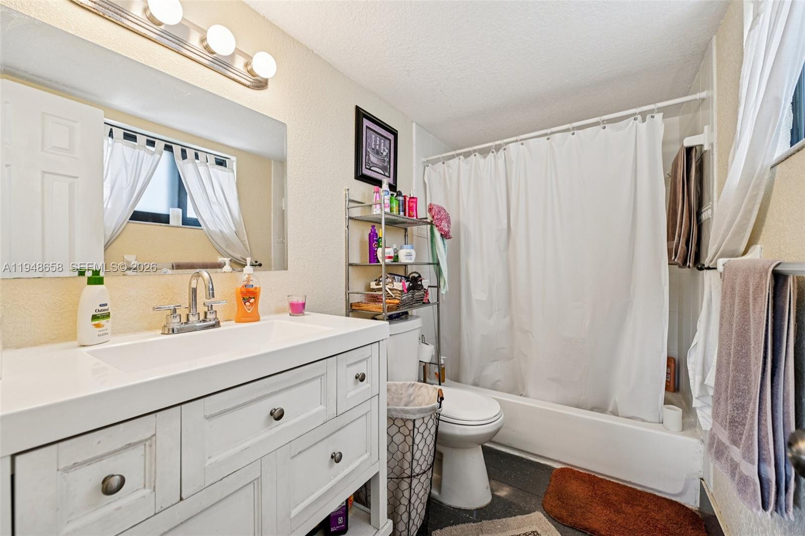 10365 Southwest 11th Terrace, Unit 49B Miami, FL 33174 - Photo 23 of 36 a bathroom with a sink toilet and shower