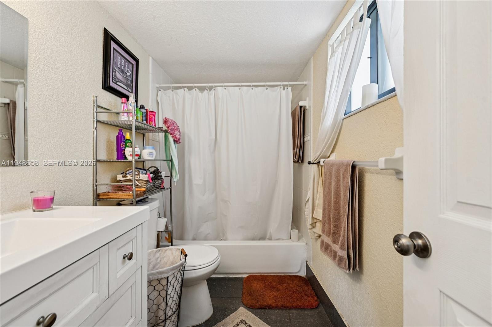 10365 Southwest 11th Terrace, Unit 49B Miami, FL 33174 - Photo 24 of 36 a bathroom with a sink toilet and shower