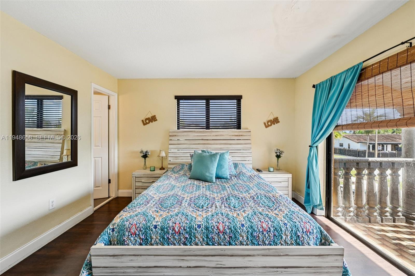 10365 Southwest 11th Terrace, Unit 49B Miami, FL 33174 - Photo 25 of 36 a bedroom with a bed and wooden floor