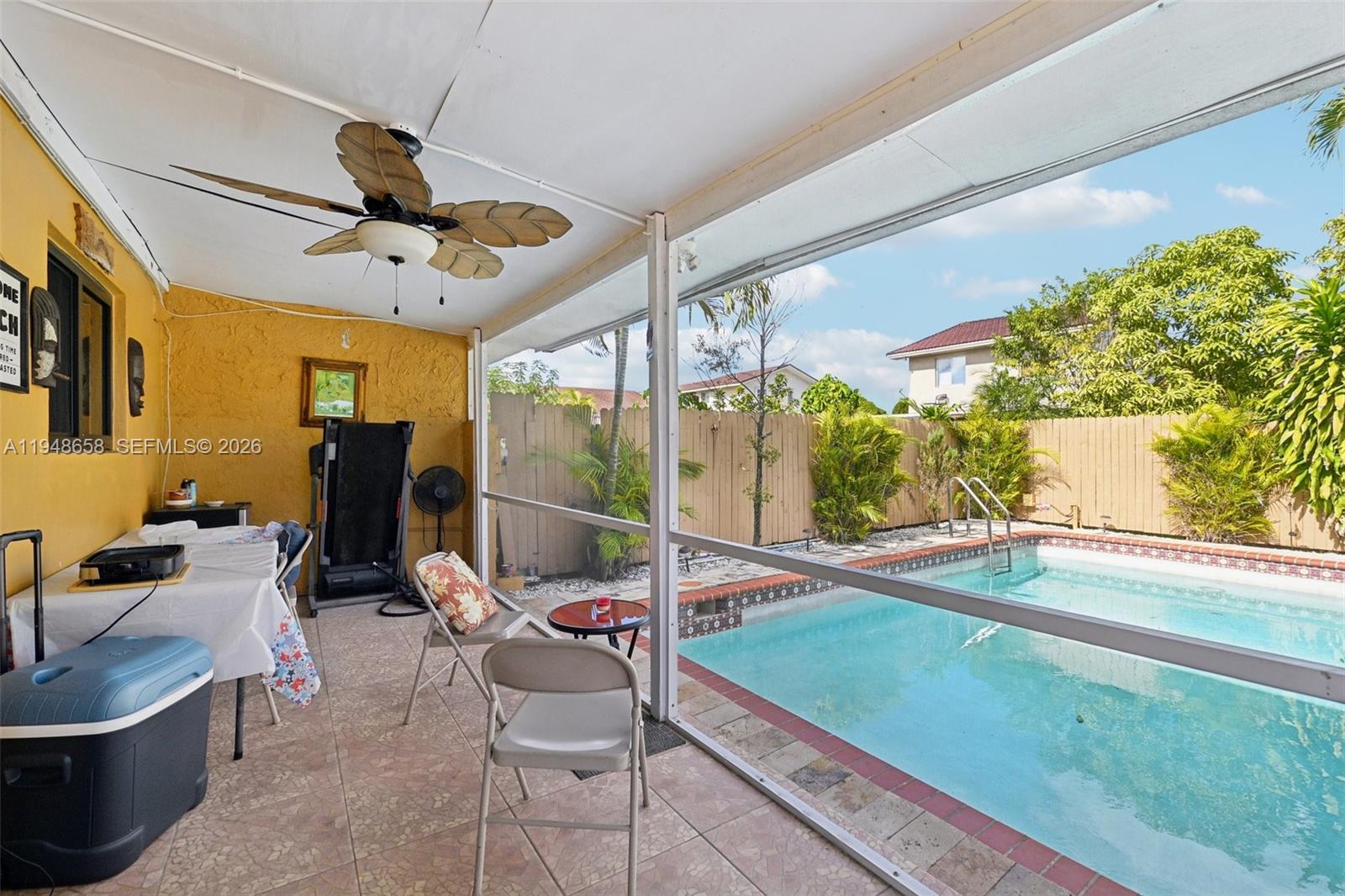 10365 Southwest 11th Terrace, Unit 49B Miami, FL 33174 - Photo 29 of 36 a room with lots of windows and flower plants