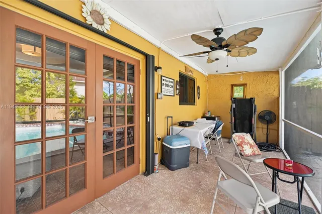 a living room with furniture a flat screen tv and a large window