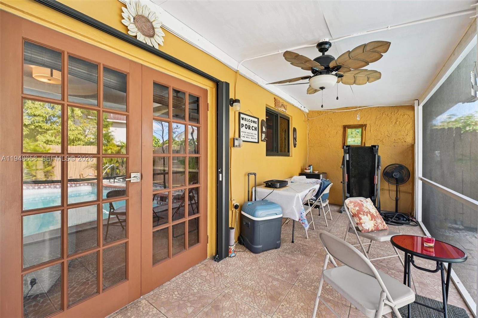 10365 Southwest 11th Terrace, Unit 49B Miami, FL 33174 - Photo 30 of 36 a living room with furniture a flat screen tv and a large window
