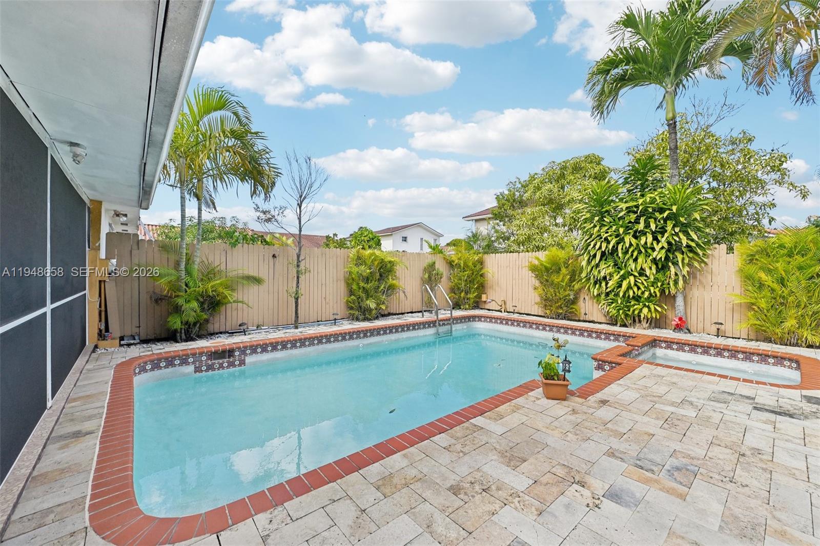10365 Southwest 11th Terrace, Unit 49B Miami, FL 33174 - Photo 31 of 36 a view of swimming pool with a backyard and seating space