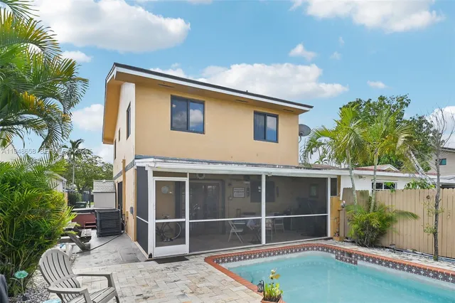 a backyard of a house with table and chairs