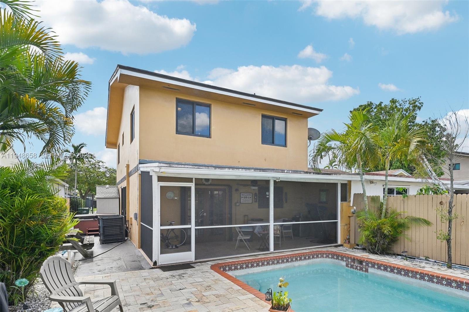 10365 Southwest 11th Terrace, Unit 49B Miami, FL 33174 - Photo 32 of 36 a backyard of a house with table and chairs