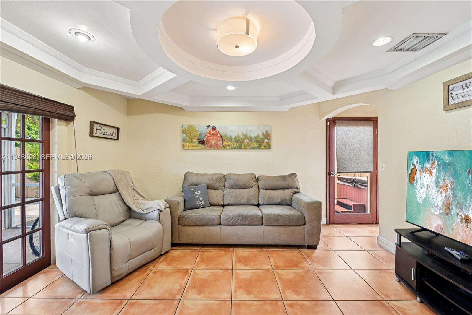 10365 Southwest 11th Terrace, Unit 49B Miami, FL 33174 - Photo 5 of 36 a living room with furniture and a flat screen tv