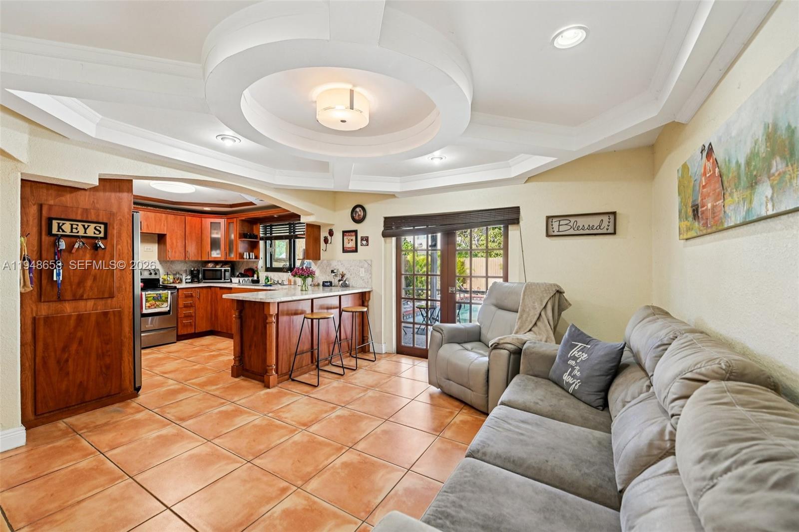 10365 Southwest 11th Terrace, Unit 49B Miami, FL 33174 - Photo 6 of 36 a living room with fireplace furniture and a large window