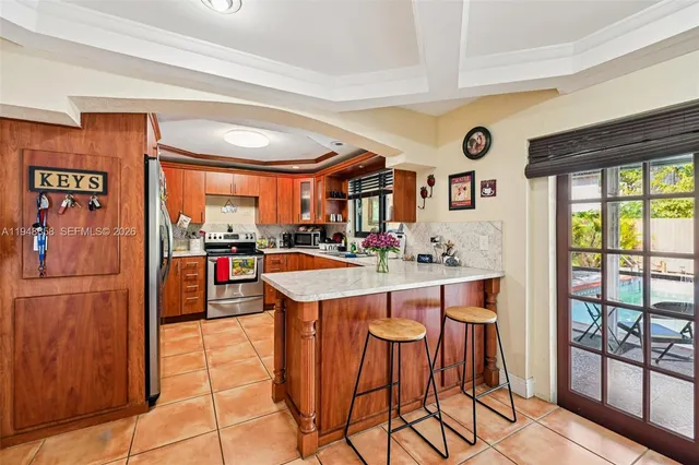 a kitchen with stainless steel appliances granite countertop a sink and a refrigerator