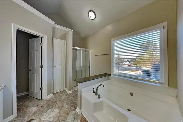 a bathroom with a bathtub and a shower
