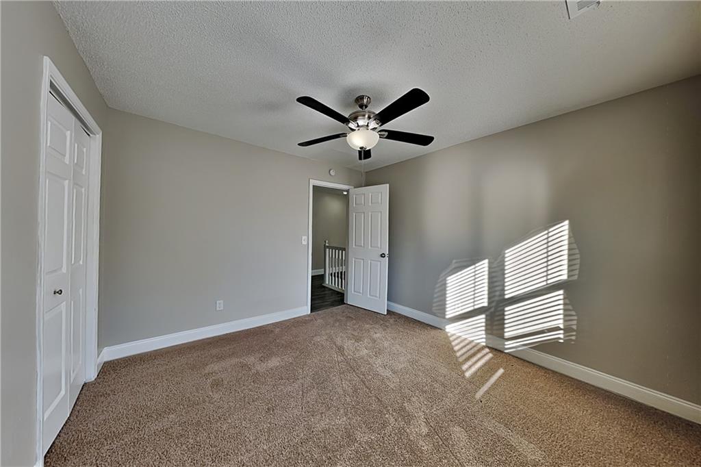 5305 Rutland Court Powder Springs, GA 30127 - Photo 12 of 22 a view of an empty room with a ceiling fan