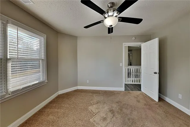 en view interior of a room with a ceiling fan and window