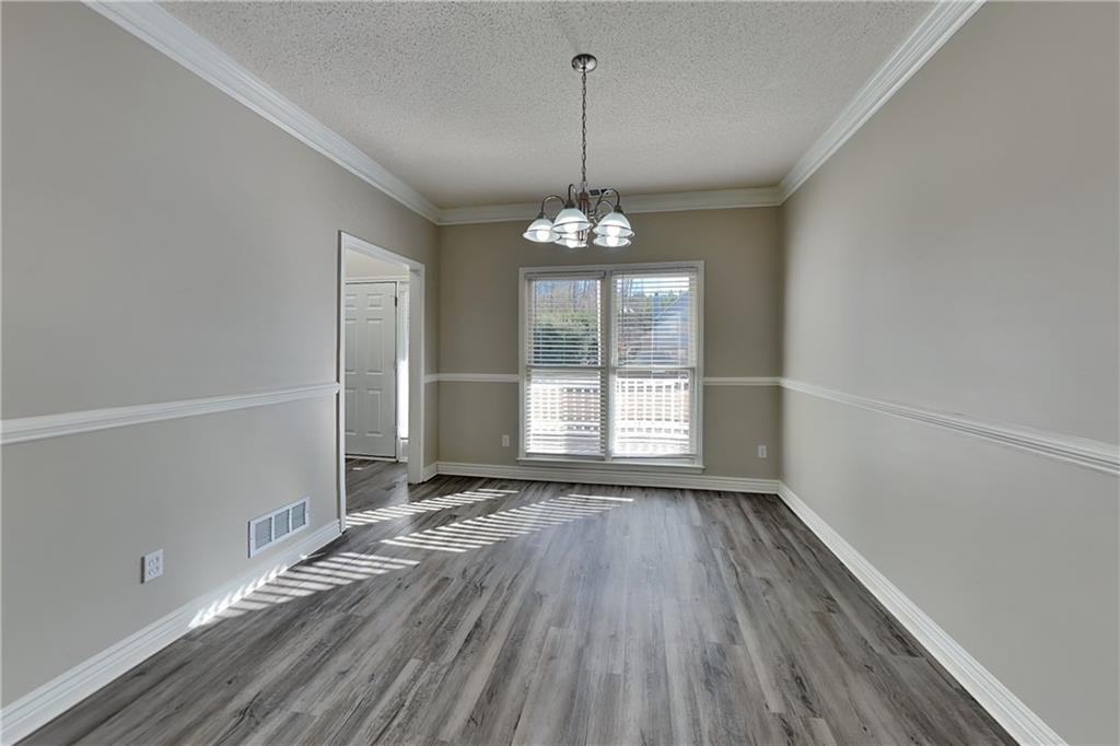5305 Rutland Court Powder Springs, GA 30127 - Photo 7 of 22 a view of a room with wooden floor exposed radiator and windows