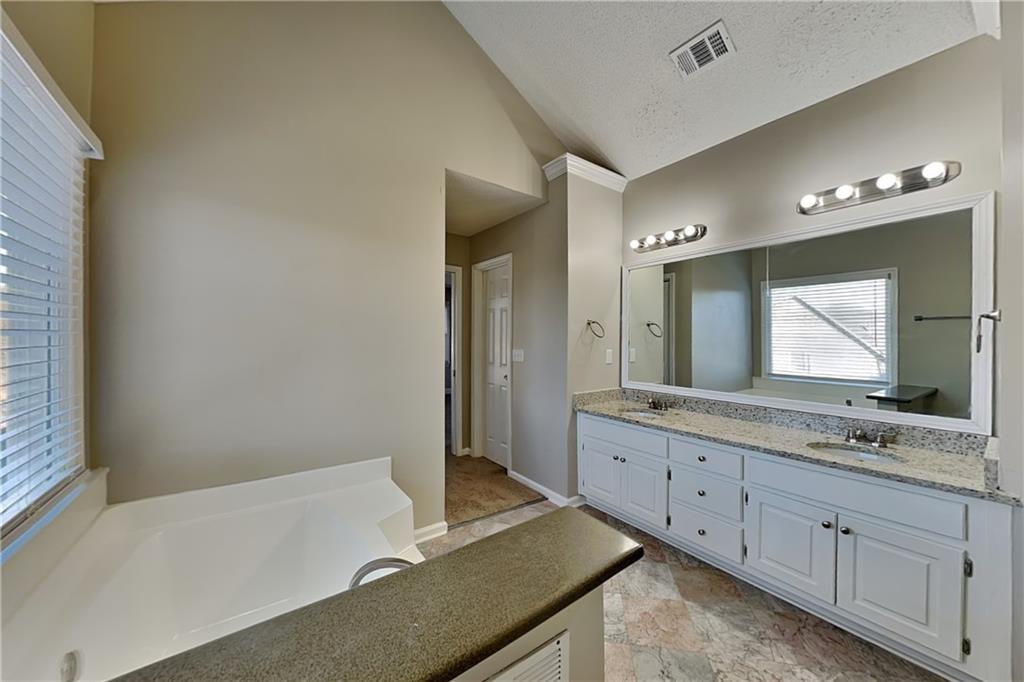 5305 Rutland Court Powder Springs, GA 30127 - Photo 10 of 22 a bathroom with a tub sink and mirror