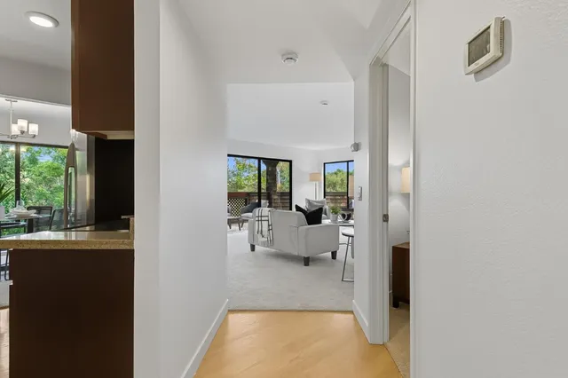 a view of living room with furniture and large windows