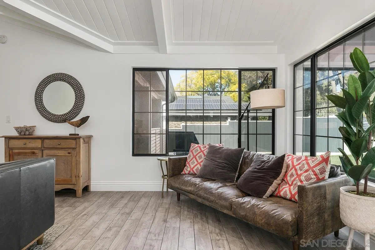 970 Saxony Road Encinitas, CA 92024 - Photo 13 of 39 a living room with furniture and a floor to ceiling window