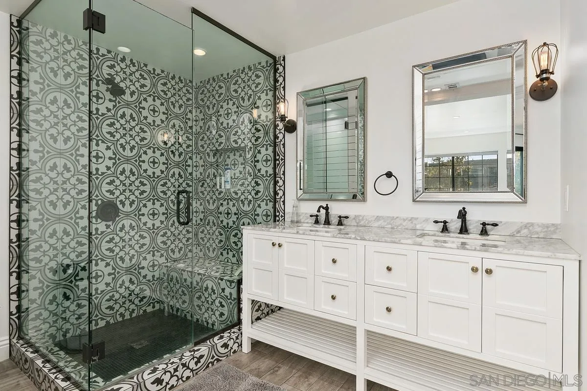 970 Saxony Road Encinitas, CA 92024 - Photo 15 of 39 a bathroom with a shower sink and mirror