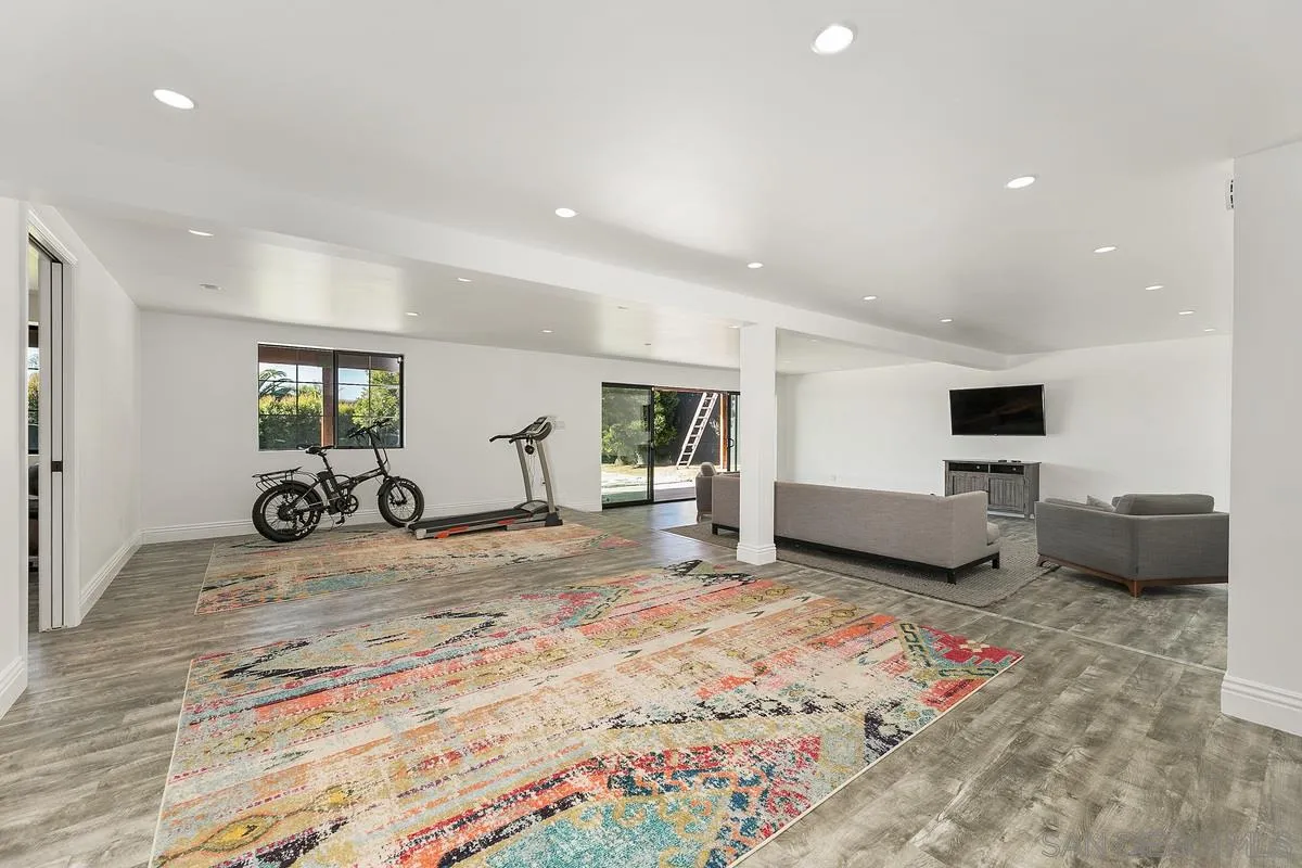 970 Saxony Road Encinitas, CA 92024 - Photo 18 of 39 a living room with furniture and a flat screen tv