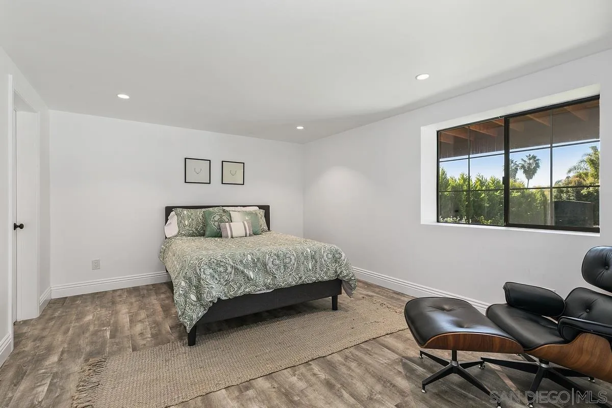 970 Saxony Road Encinitas, CA 92024 - Photo 21 of 39 a bedroom with a bed and window