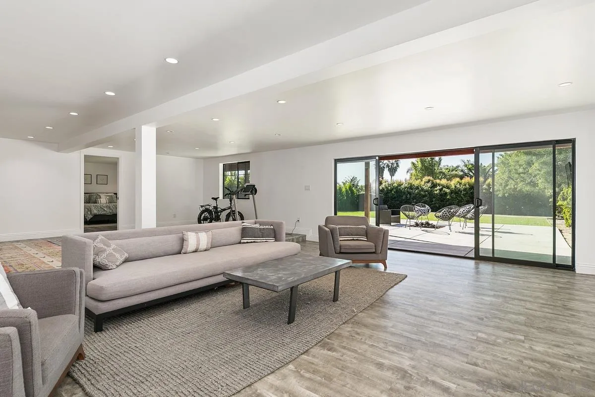 970 Saxony Road Encinitas, CA 92024 - Photo 23 of 39 a living room with furniture and a large window